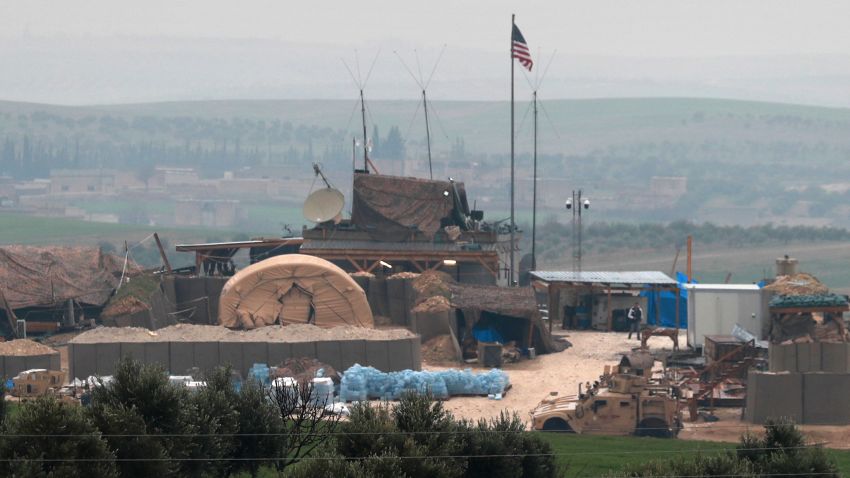 US forces' vehicles and structures are seen on the outskirts of the northern Syrian town of Manbij in the village of Dadat, on the demarcation line separating pro-Turkish factions and opposing US-backed Syrian Kurdish fighters, on December 26, 2018. - Pro-Turkish armed groups have reinforced their presence on the outskirts of the city of Manbij in northern Syria as Ankara threatens a new offensive against Kurdish forces. The United States has backed Kurdish fighters in northern Syria as part of an international coalition against the Islamic State jihadist group. But a surprise announcement by US President Donald Trump a week ago that he will pull American troops out of the country has left the Kurds exposed to attack. (Photo by Delil souleiman / AFP) (Photo credit should read DELIL SOULEIMAN/AFP/Getty Images)