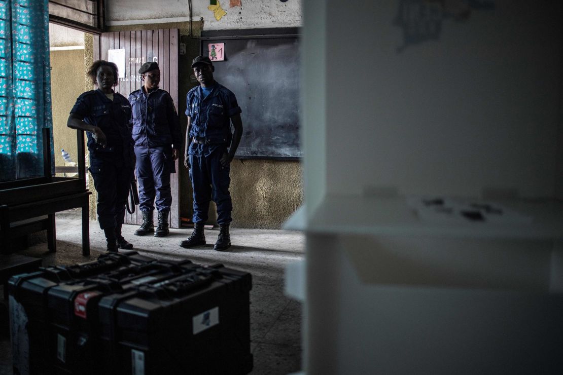 Congolese policemen guard voting machines in a school where the voting material is stocked in Kinshasa's Victoire district.