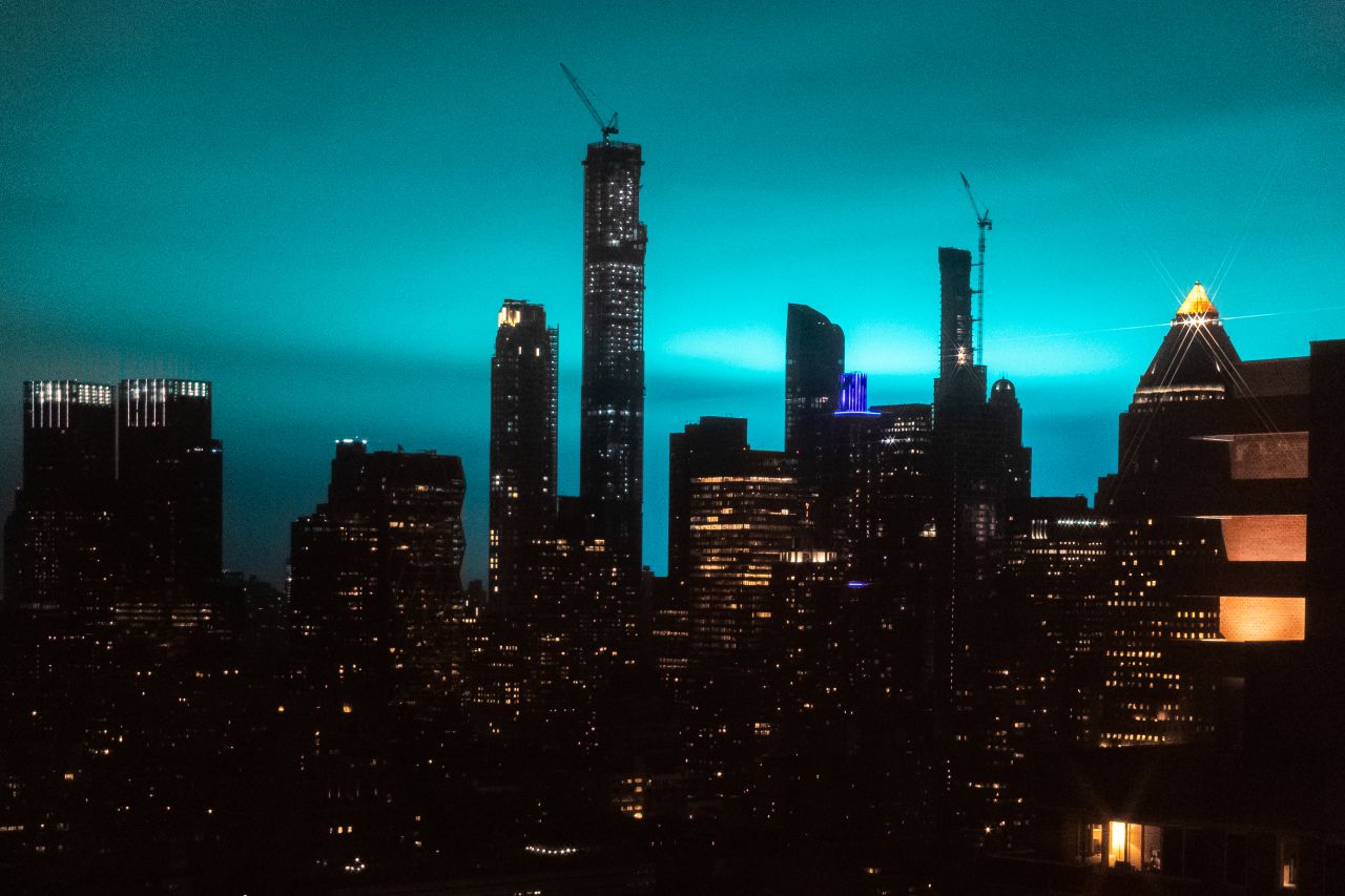 Buildings are silhouetted as the night sky is illuminated by blue light in New York, on Thursday, December 27. After initial reports of a transformer explosion at a Consolidated Edison Inc. power plant, the power company said the light came as part of an electrical fault that caused an "arc flash."