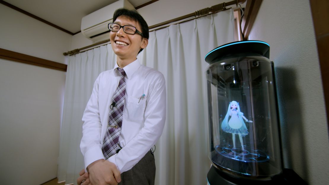 Kondo smiles next to his new bride Hatsune Miku.