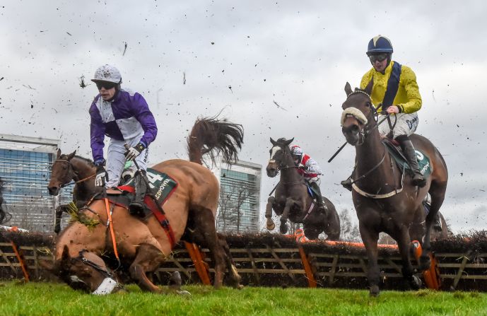 Denis O'Regan, left, falls during the Paddy Power 'Enough of your Nonsense' Handicap Hurdle on  Thursday, December 27, day two of the Leopardstown Festival in Dublin, Ireland. 