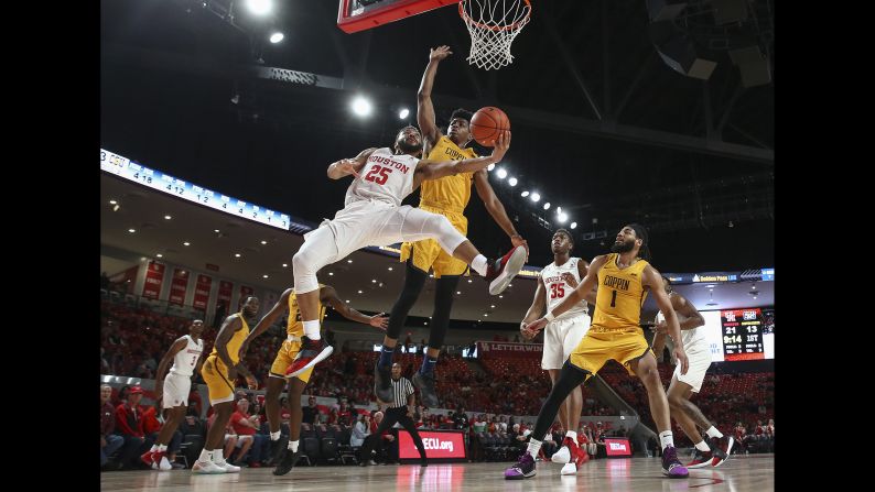 Houston Cougars guard Galen Robinson Jr., left, attempts to score as Coppin State Eagles forward Cedric Council defends during the first half on December 23 in Houston.
