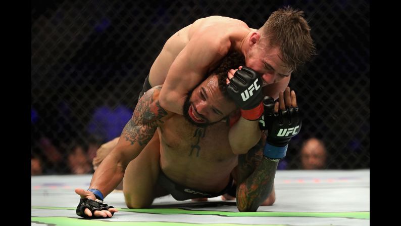 Great Britain's Nathaniel Wood, top, defeats Andre Ewell by submission during a bantamweight match at a UFC event on December 29 in Inglewood, California.