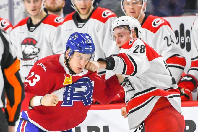 Laval Rockets' Michael Pezzetta, left, and Charlotte Checkers' Dan Renouf fight during a game on December 29 in Laval, Québec. 