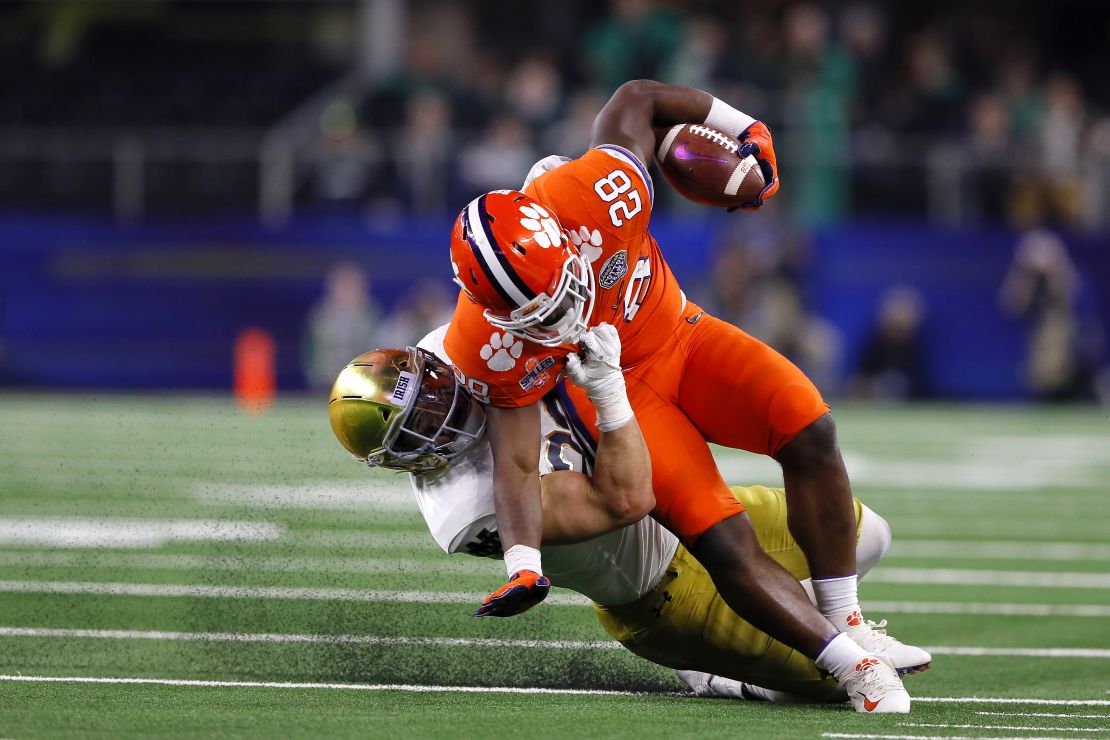 Drue Tranquill of the Notre Dame Fighting Irish tackles Clemson Tigers' Tavien Feaster in the second half during the College Football Playoff Semifinal Goodyear Cotton Bowl Classic.