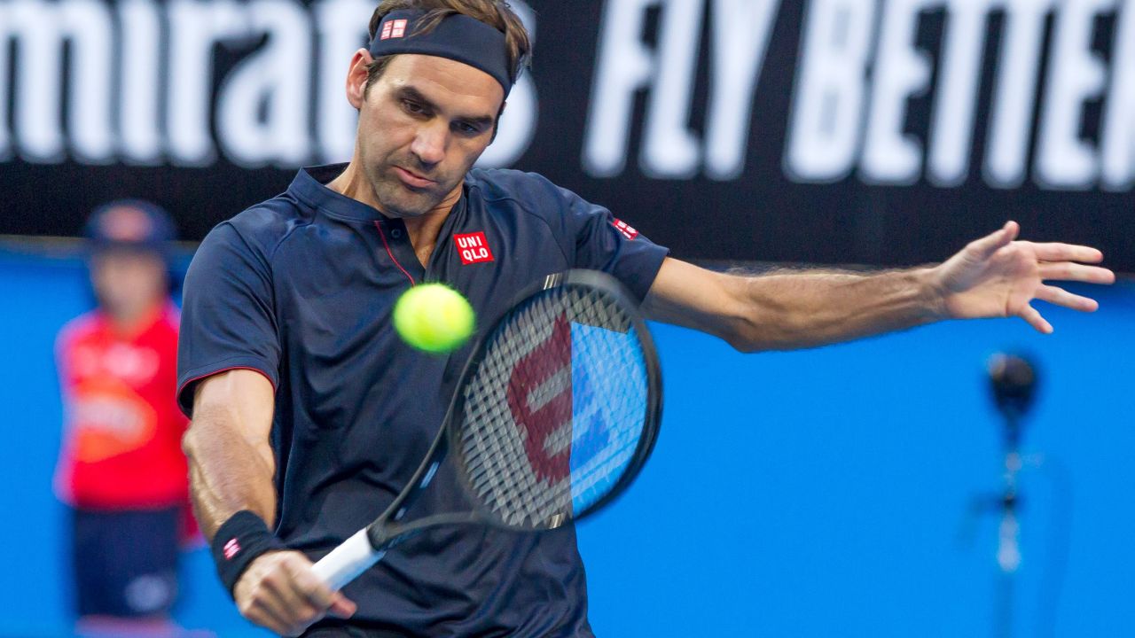 Roger Federer of Switzerland hits a return against Cameron Norrie of Britain during their fourth session men's singles match on day two of the Hopman Cup tennis tournament in Perth on December 30, 2018. (Photo by TONY ASHBY / AFP) / -- IMAGE RESTRICTED TO EDITORIAL USE - STRICTLY NO COMMERCIAL USE --        (Photo credit should read TONY ASHBY/AFP/Getty Images)