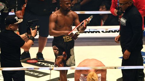 Floyd Mayweather holds the trophy aloft after beating his youthful opponent Tenshin Nasukawa at the Saitama Super Arena in Japan.