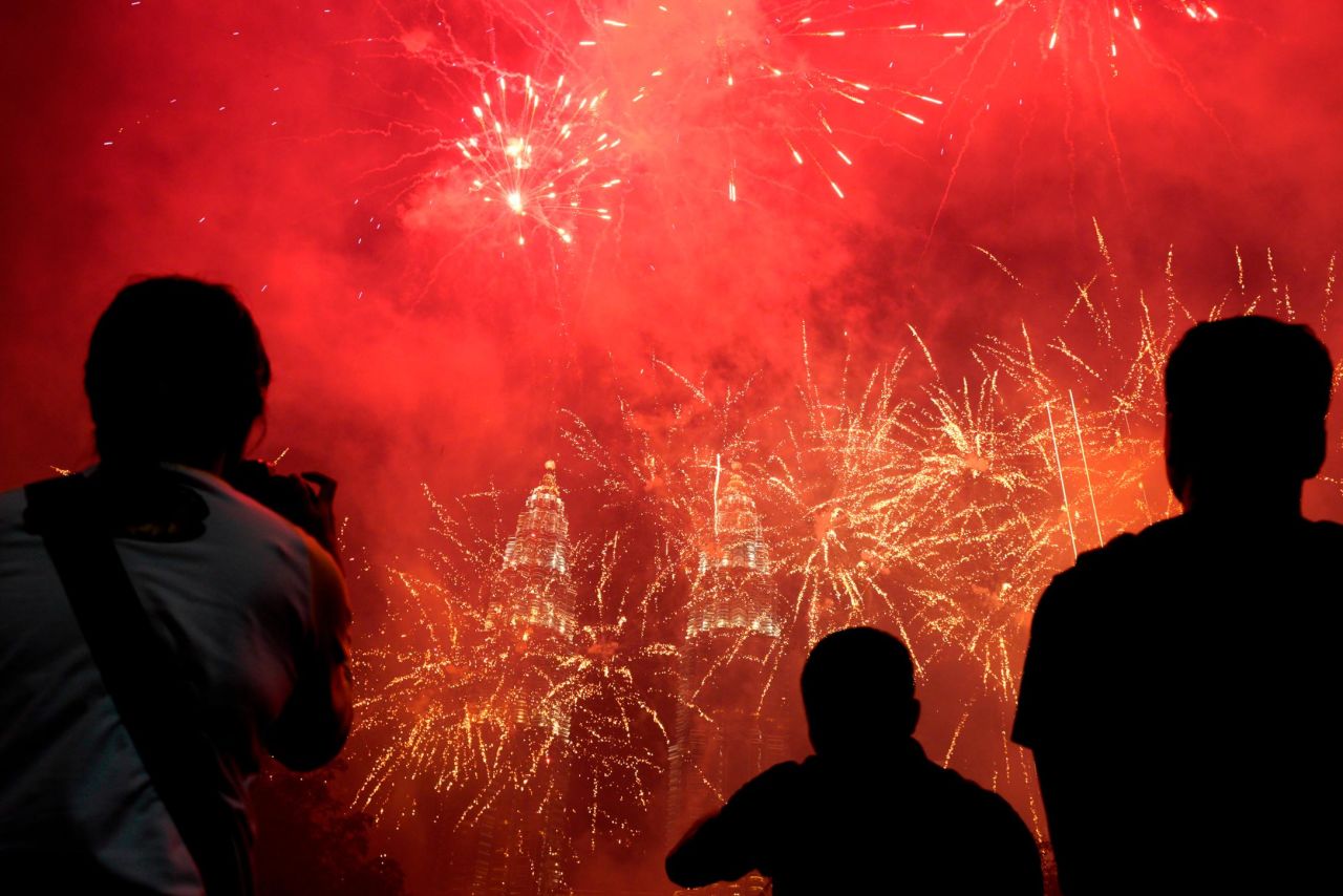 Fireworks light up the sky in front of the Petronas Twin Towers in Kuala Lumpur, Malaysia.