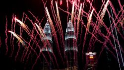 Fireworks explode in front of Malaysia's landmark building, the Petronas Twin Towers, during the New Year's celebration in Kuala Lumpur, Malaysia, Tuesday, Jan. 1, 2019.(AP Photo/Yam G-Jun)