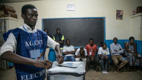 An electoral commission agent seals a ballot box in front of observers in Lubumbashi's Mapala district on December 30. 
