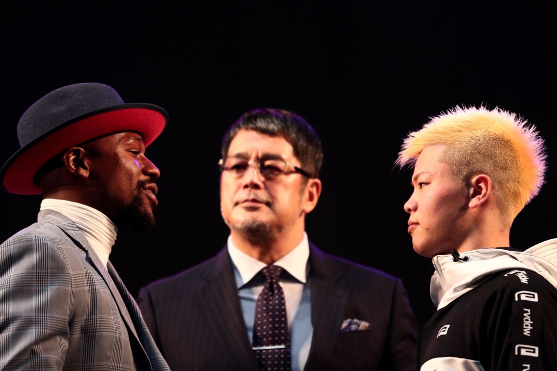 US boxing legend Floyd Mayweather Jr and kickboxer Tenshin Nasukawa of Japan pose on the stage during a weigh-in event at Saitama Super Arena.
