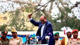 Sudanese President Omar al-Bashir (C) waves a walking stick as he gives a speech in Nyala, the capital of South Darfur province, on September 21, 2017.
Bashir, wanted by the International Criminal Court on charges of genocide and war crimes related to the conflict in Darfur, is touring the region ahead of a US decision to be made on October 12, 2017 on whether to permanently lift a decades-old trade embargo on Sudan. / AFP PHOTO / ASHRAF SHAZLY        (Photo credit should read ASHRAF SHAZLY/AFP/Getty Images)
