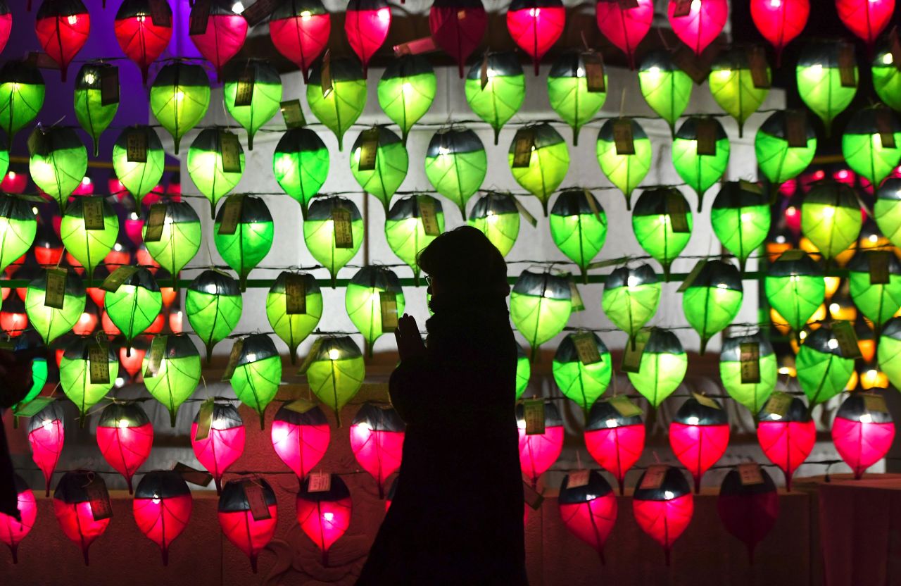 A Buddhist prays in front of lanterns during celebrations to mark 2019 at Jogyesa temple in Seoul, South Korea.