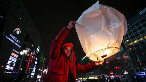 A boy releases a balloon carrying his personal wishes as people gather at Kizilay Square in Ankara, Turkey.