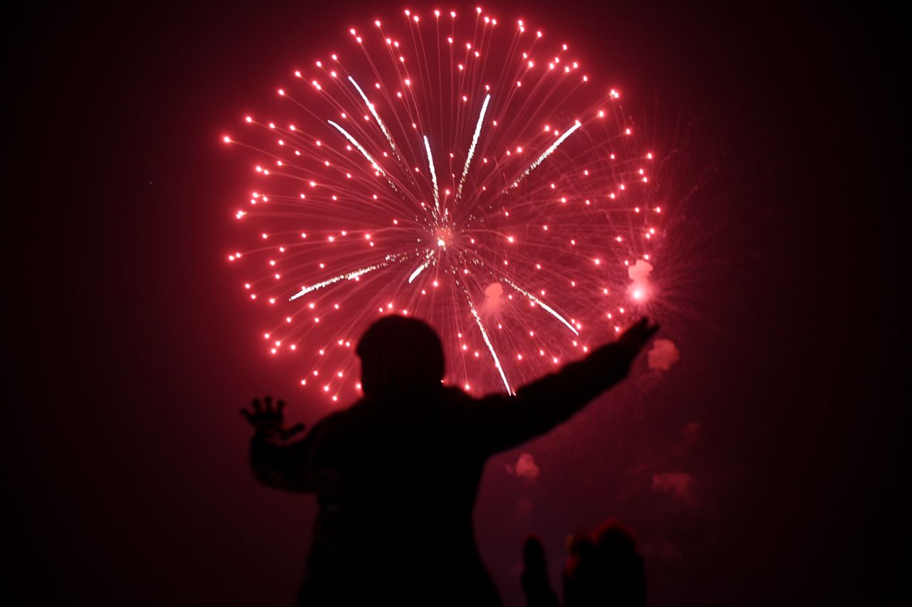 A man watches the fireworks display in Karachi, Pakistan.