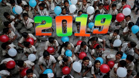 Schoolchildren hold balloons during New Year's celebrations at their school in Ahmedabad, India.