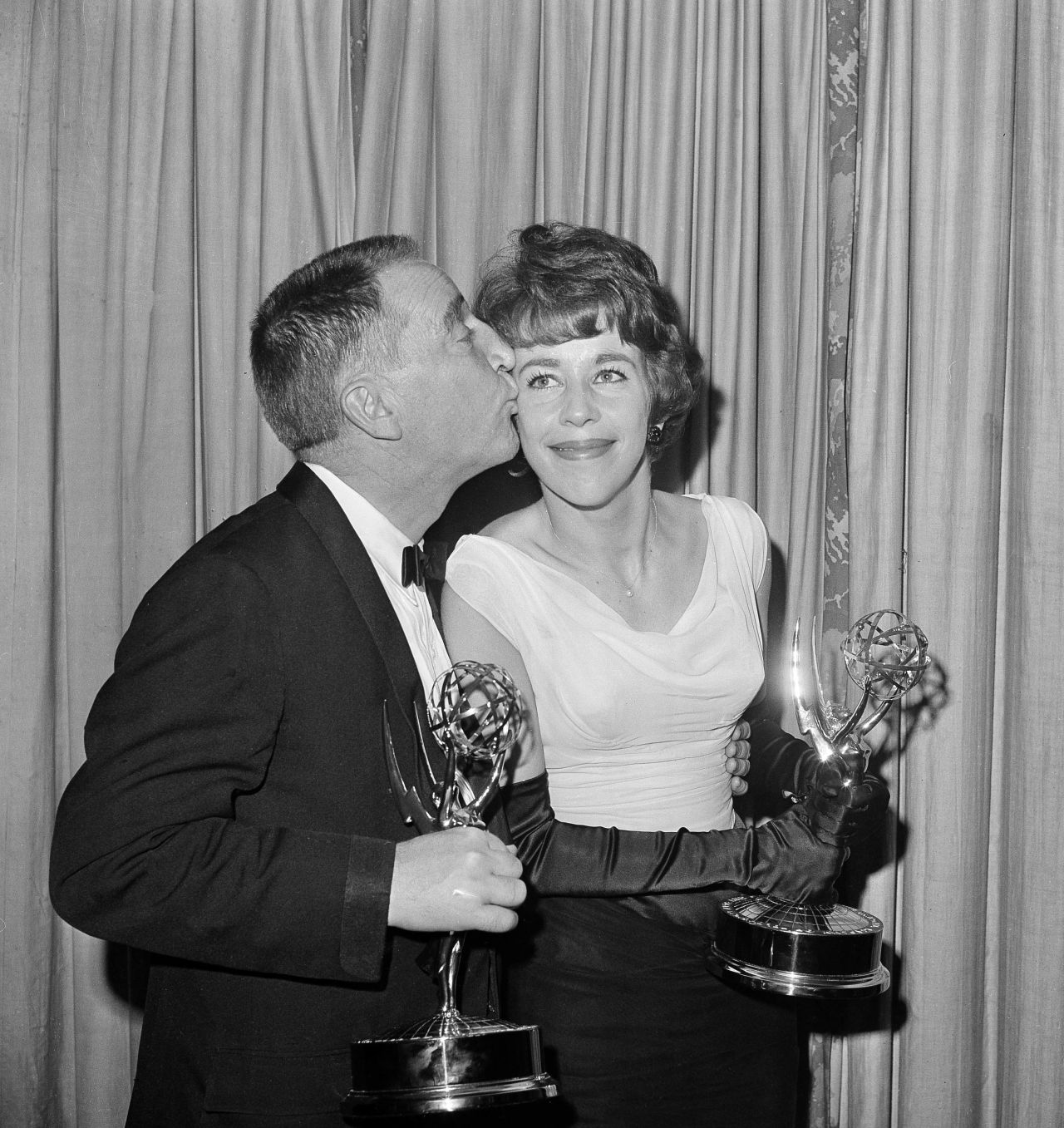Garry Moore kisses Burnett in 1962 after they both received Emmy Awards for their work on "The Garry Moore Show."