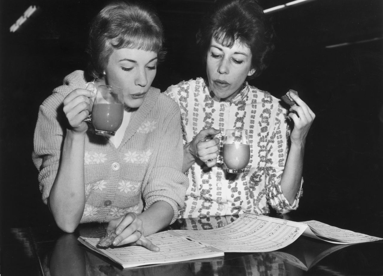 Julie Andrews, left, and Burnett drink tea while reviewing the musical score for their 1962 TV special "Julie and Carol at Carnegie Hall."