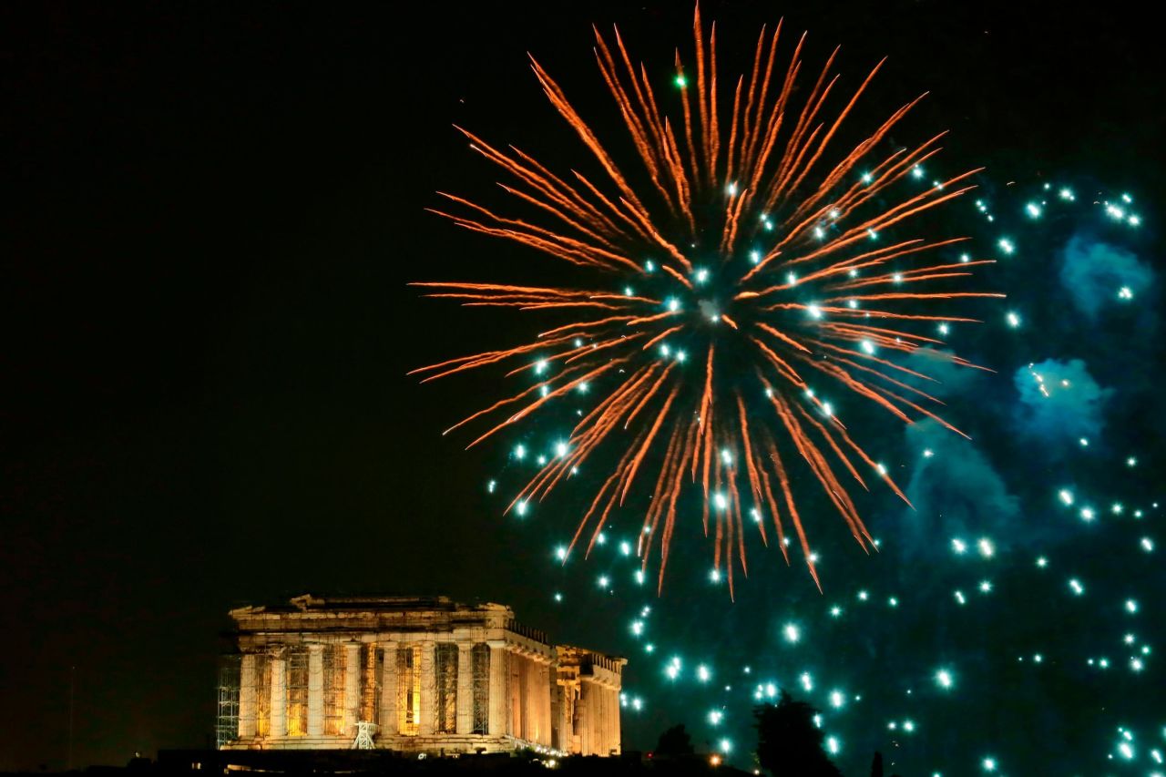 Fireworks explode above the ancient Parthenon temple atop the Acropolis in Athens, Greece.