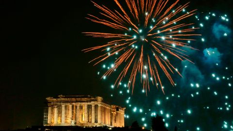 Fireworks explode above the ancient Parthenon temple atop the Acropolis in Athens, Greece.