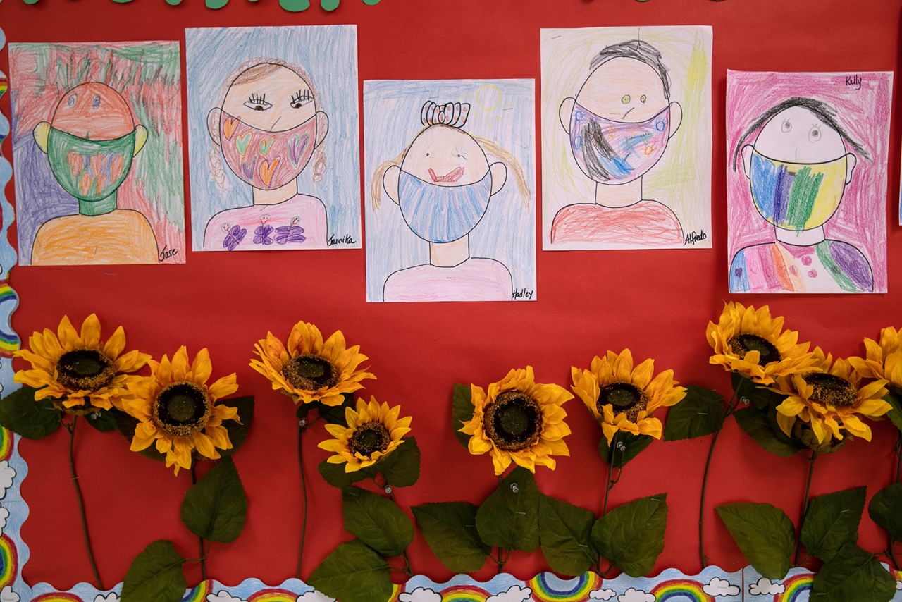 Drawings of children wearing masks adorn a hallway at Stark Elementary School on September 16, in Stamford, Connecticut.