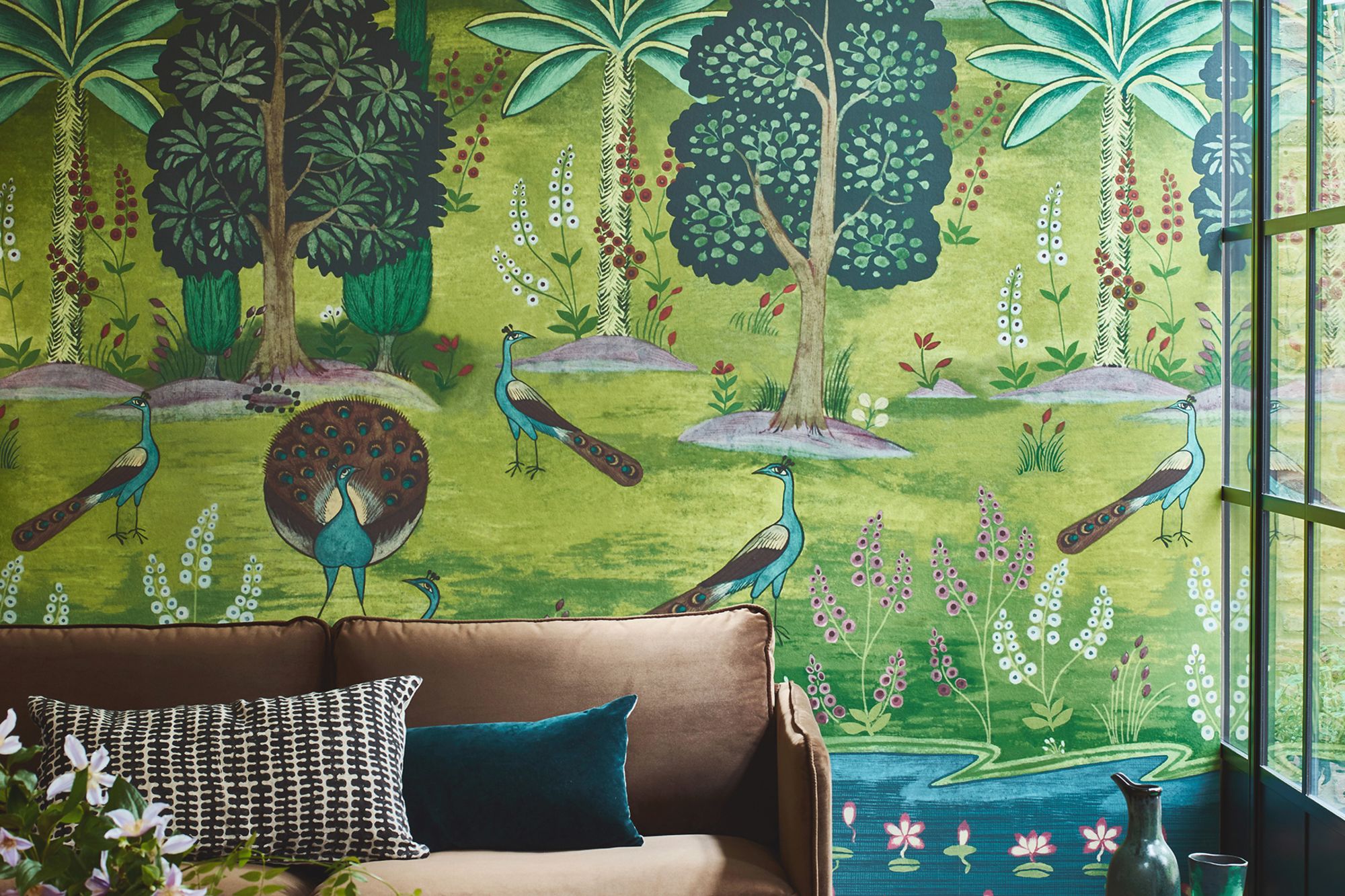 Featuring peacocks, stylized palms and lotus blossoms on a tranquil river, this "Garland of Ragini" wall mural is based on an Indian artwork from the early 18th century.