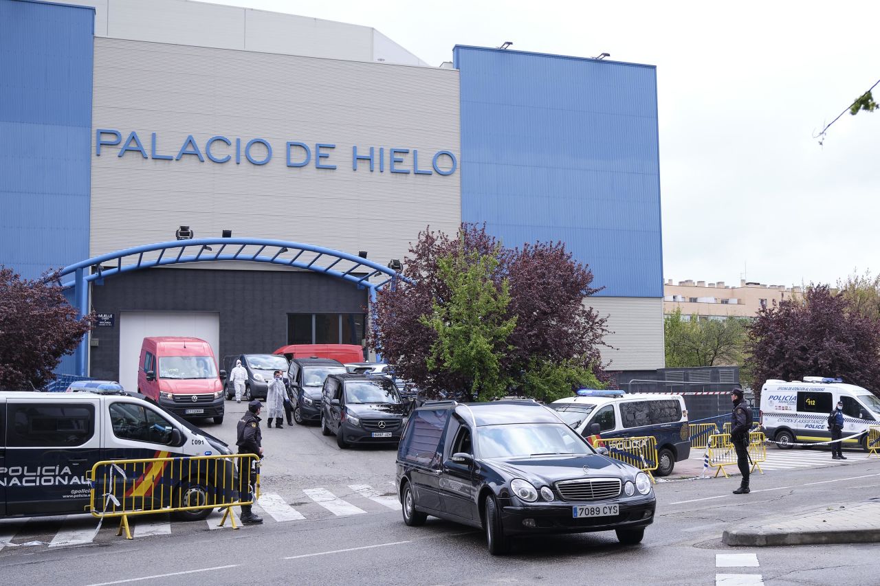 Funeral cars and vans wait outside the Palacio de Hielo in Madrid, Spain, on March 27, where coronavirus victims' bodies are kept at an ice rink temporarily converted into a morgue.