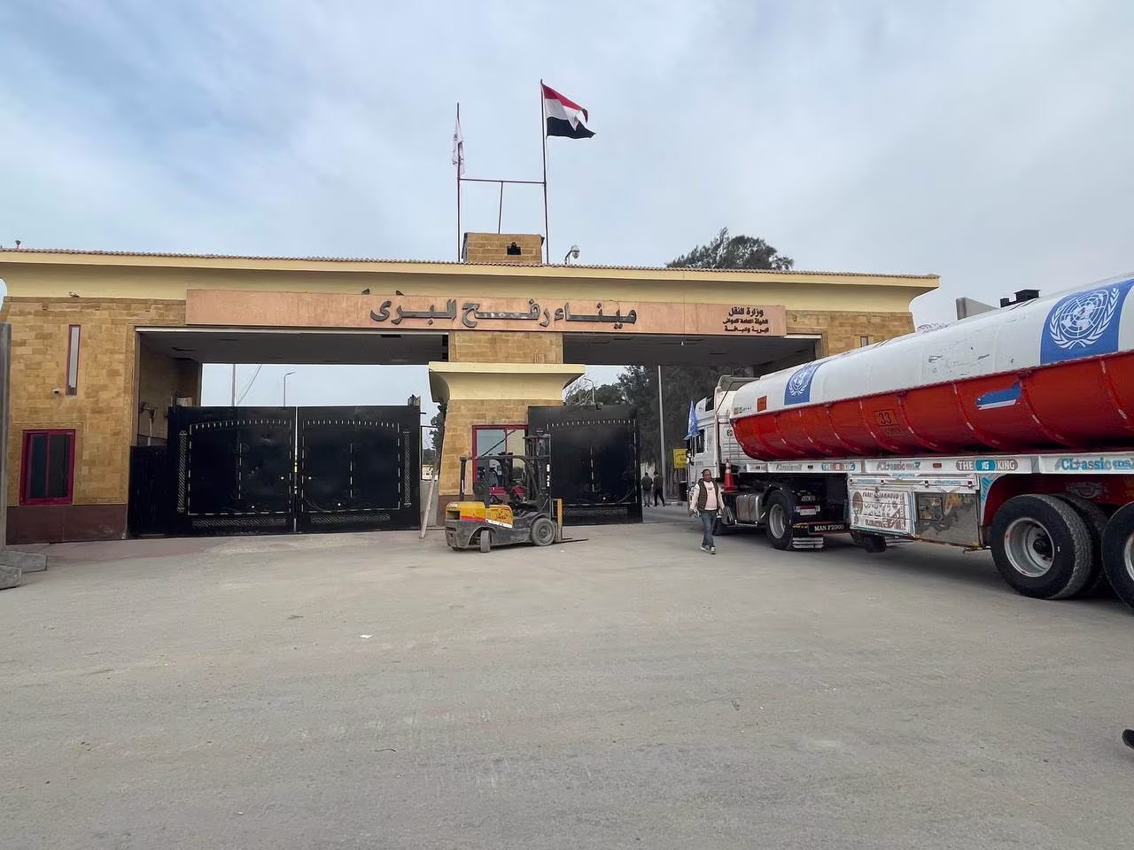 Trucks with humanitarian aid and fuel wait to enter Gaza through the Rafah border crossing in Egypt on Sunday, December 10.