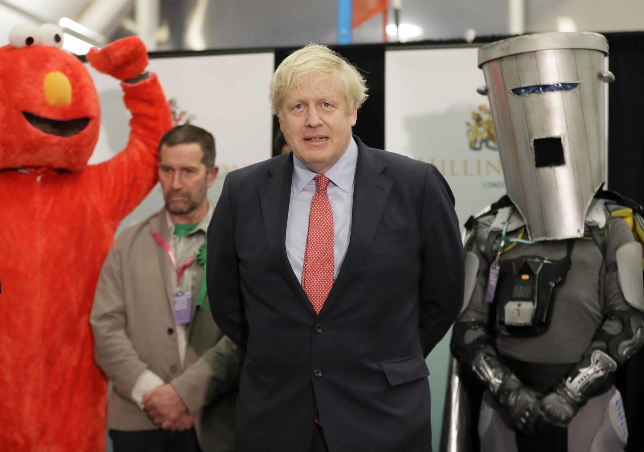 Prime Minister Boris Johnson is joined on stage by Bobby Smith, leader of the 'Give Me Back Elmo' party, and Independent candidate Count Binface during the count declaration at Brunel University in Uxbridge, London. Photo: Kirsty Wigglesworth/AP