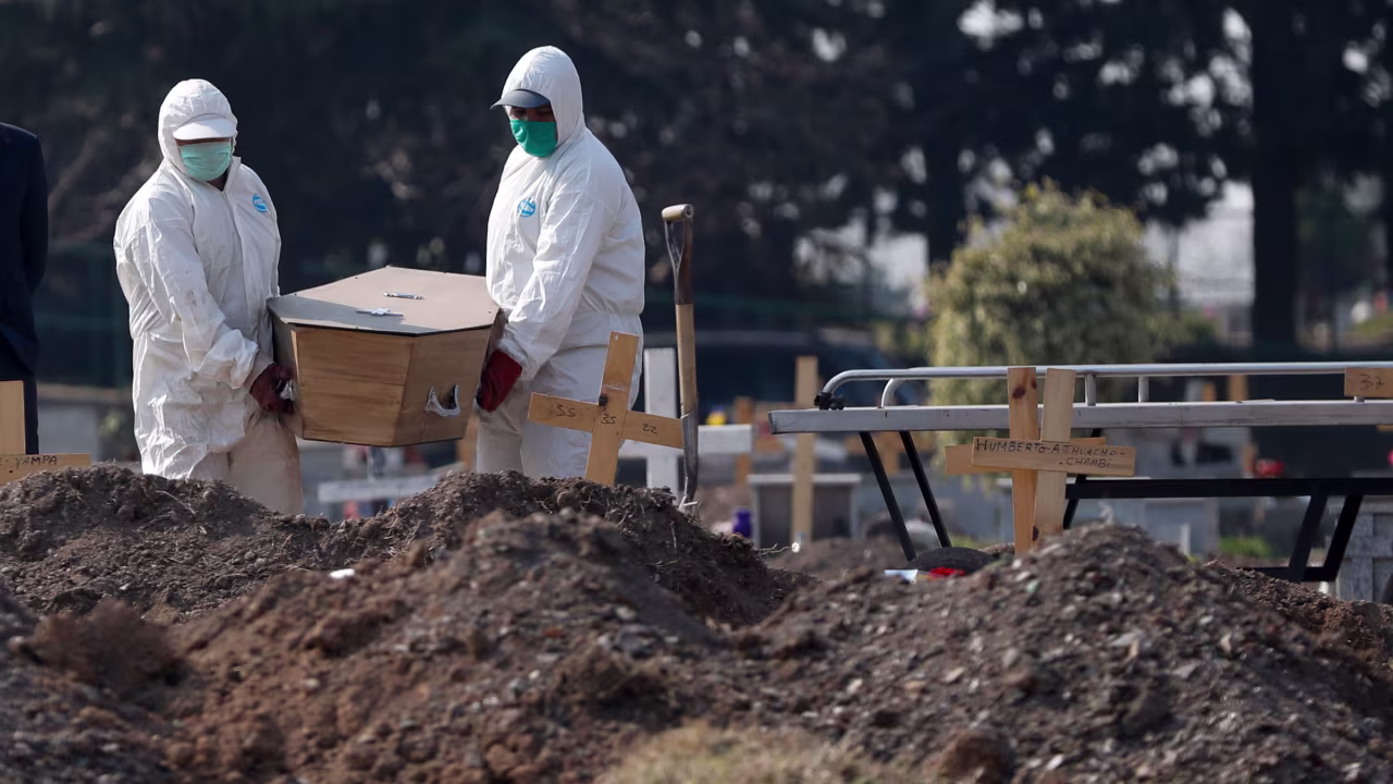 Cemetery workers in Buenos Aires carry a person's remains to the section of the Flores Cemetery where Covid-19 victims are being buried.