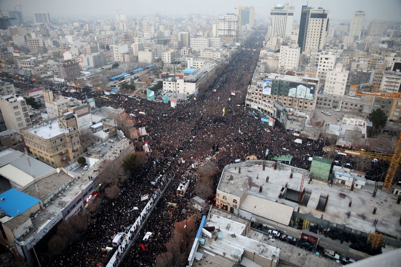 ?Iranians march behind a vehicle carrying the coffins of slain major general Qasem Soleimani and others as they pay homage in the northeastern city of Mashhad on Jan. 5.