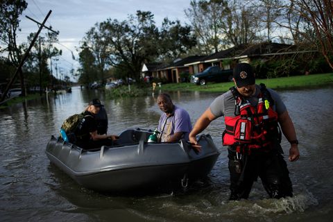 First responders rescue a resident from floodwater left behind by Hurricane Ida in LaPlace, Louisiana, on Monday, August 30. 