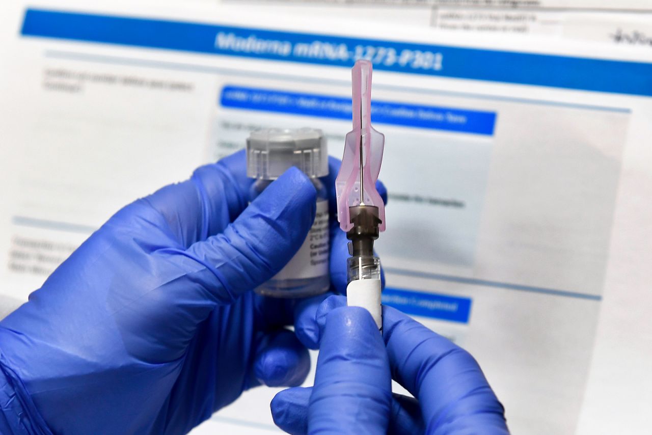 In this July 27, 2020, file photo, a nurse prepares a shot as a study of a possible Covid-19 vaccine, developed by the National Institutes of Health and Moderna Inc., in Binghamton, New York. 