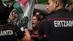 People hold Palestinian flags as they try to disrupt the eleventh stage of the Spanish Vuelta cycling race, from Bilbao to Bilbao, Spain, Wednesday, Sept. 3, 2025. (AP Photo/Miguel Oses)
