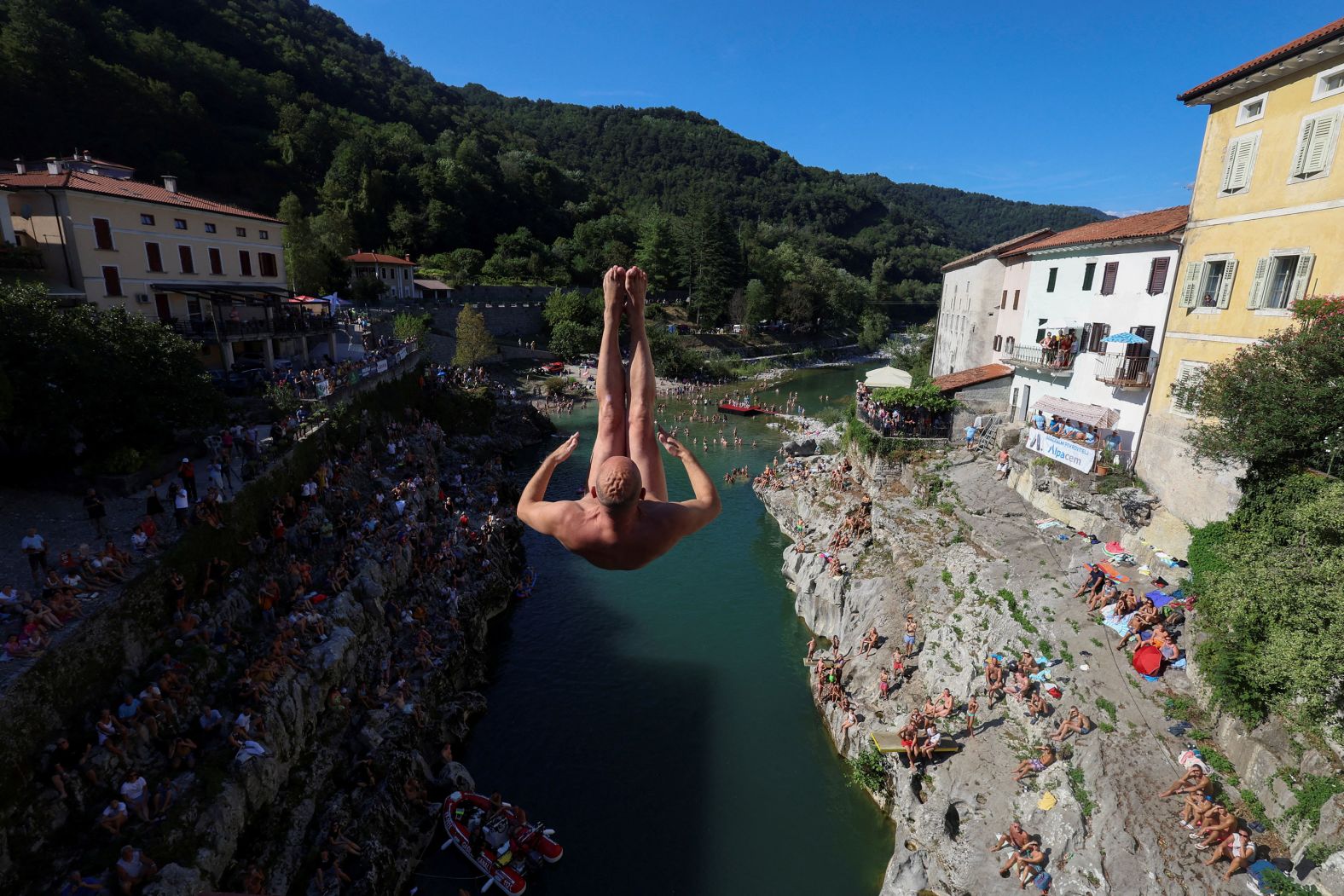 A man jumps from a bridge during a diving exhibition in Kanal, Slovenia, on Sunday, August 11.