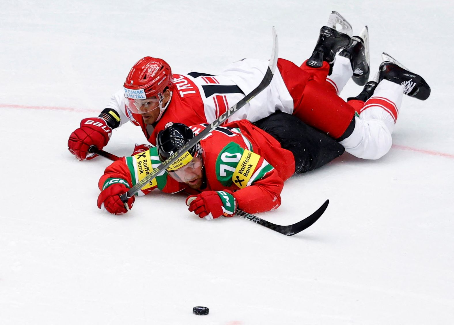 Denmark’s Alexander True and Hungary's Zsombor Garát eye the puck during a game in Herning, Denmark, on Friday, May 16.
