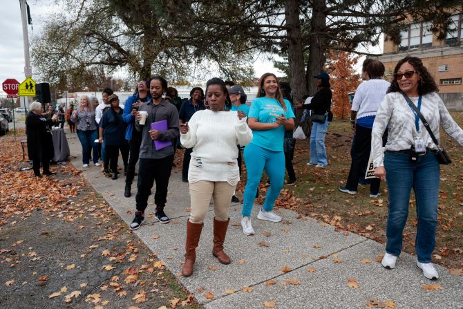 People dance outside a polling precinct in Detroit on Tuesday.