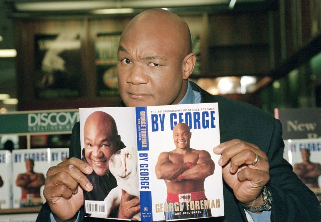 Foreman poses with a copy of his autobiography, "By George," at a book signing in New York in 1995.