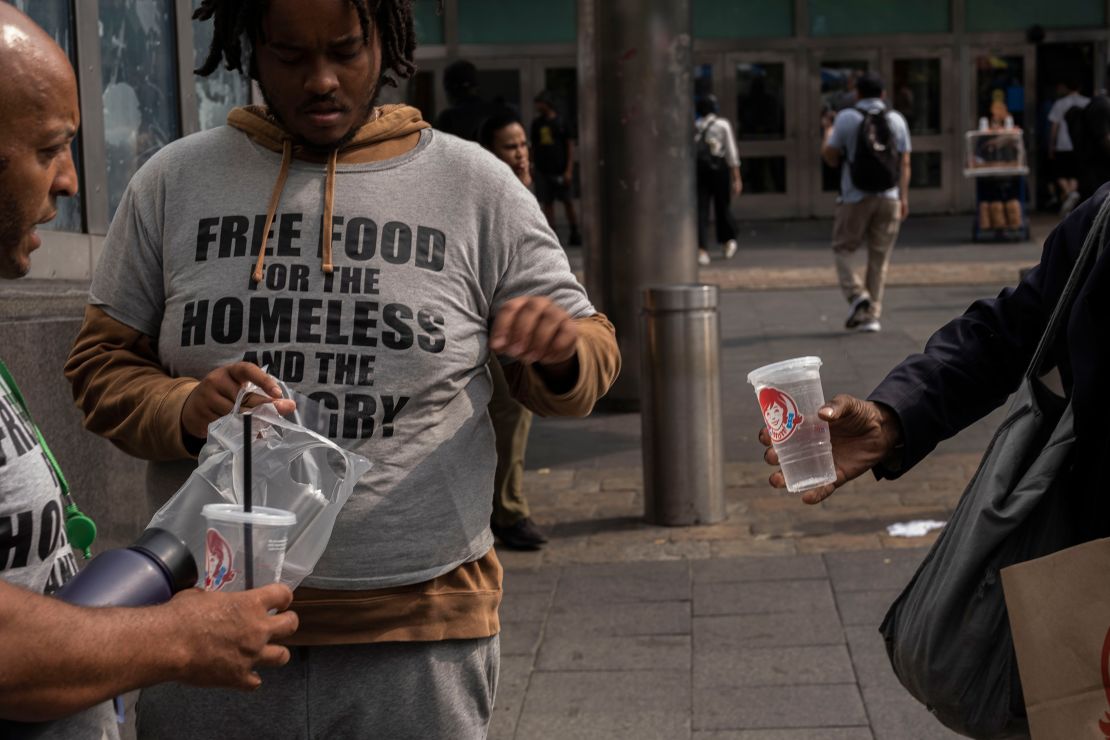 Henry and Carl Thomas distribute food outside the Staten Island ferry terminal.