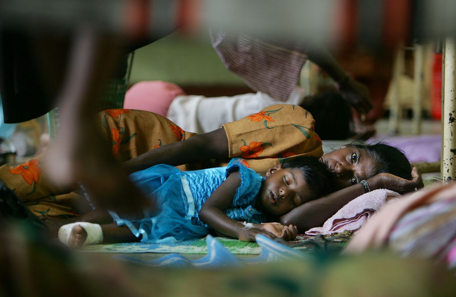 Injured tsunami victims sleep on the floor of a women's ward at the Vavaniya Hospital in Vavaniya, Sri Lanka.