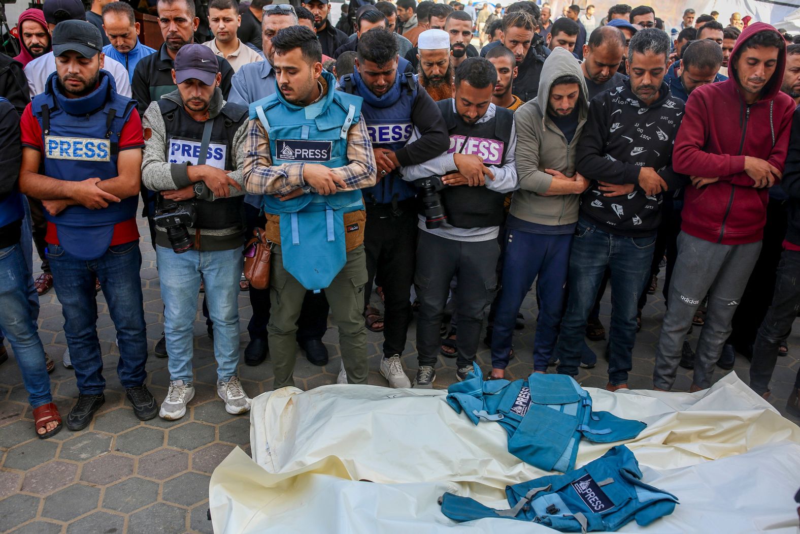 Palestinian journalists pray November 19 over the bodies of colleagues Sari Mansour and Hassouna Eslim, who were killed in an Israeli raid at the Bureij refugee camp in central Gaza.