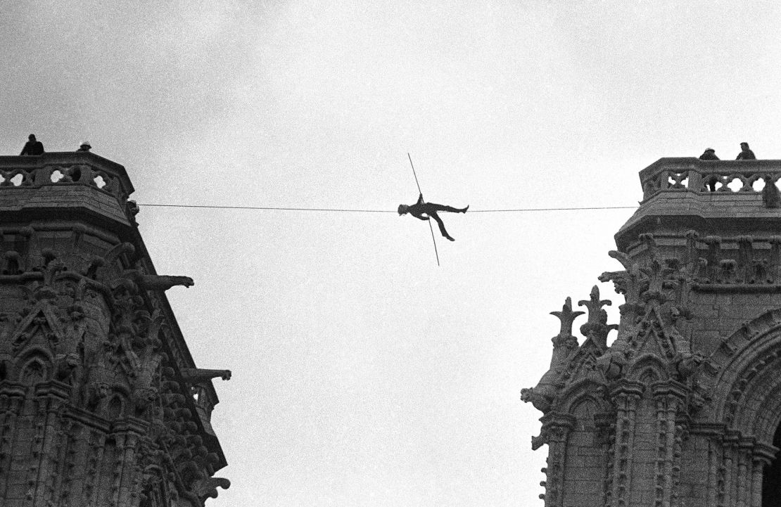 Philippe Petit, a French high-wire artist, performs an authorized tightrope walk between Notre Dame's bell towers in 1971.