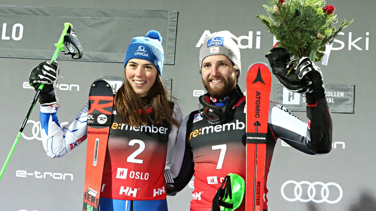Petra Vlhova of Slovakia shares the podium with Austria's Marco Schwarz who was claiming his first World Cup victory.