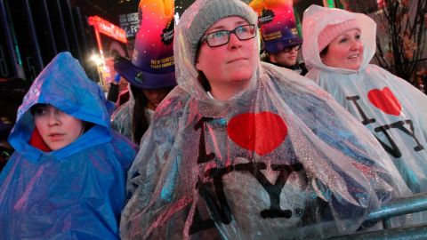 Darlene Freitas, of Ontario, Canada (center), attends New Year's Eve festivities in New York's Times Square.