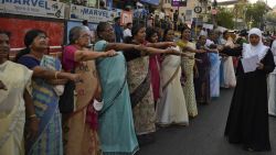 Women raise their hands to take a pledge to fight gender discrimination as they form part of a hundreds kilometer long "women's wall" in Thiruvananthapuram, in the southern Indian state of Kerala, Tuesday, Jan. 1, 2019. The wall was organized in the backdrop of conservative protestors blocking the entry of women of menstruating age at the Sabarimala temple, one of the world's largest Hindu pilgrimage sites defying a recent ruling from India's top court to let them enter. (AP Photo/R.S. Iyer)