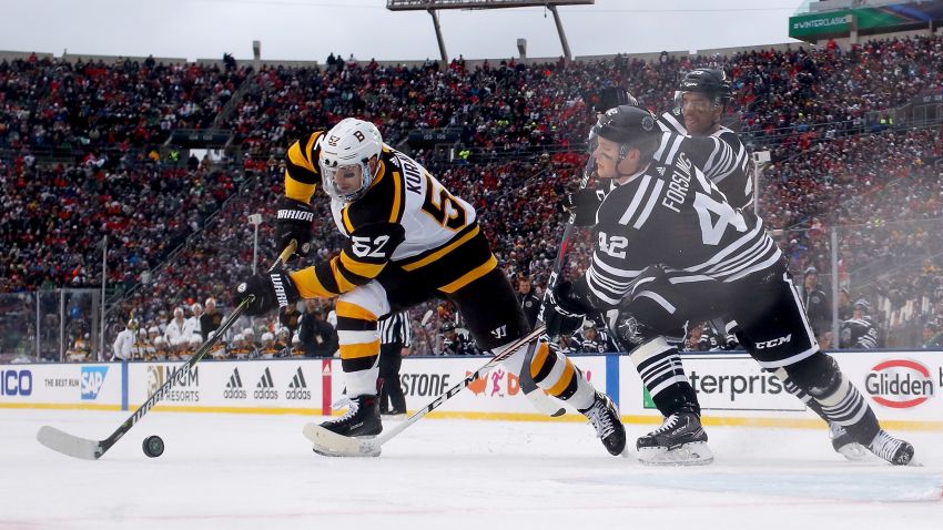 SOUTH BEND, INDIANA - JANUARY 01:  Sean Kuraly #52 of the Boston Bruins scores a goal past Gustav Forsling #42 of the Chicago Blackhawks in the third period during the 2019 Bridgestone NHL Winter Classic at Notre Dame Stadium on January 01, 2019 in South Bend, Indiana. (Photo by Gregory Shamus/Getty Images)