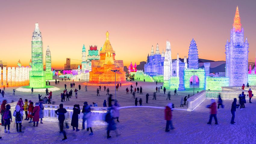 TOPSHOT - This photo taken on December 23, 2018 shows people visiting the Harbin Ice-Snow World in Harbin, China's northeastern Heilongjiang province. - The Harbin Ice and Snow Sculpture Festival will kick off in the city on January 4, 2019, which attracts hundreds of thousands of visitors annually. (Photo by STR / AFP)