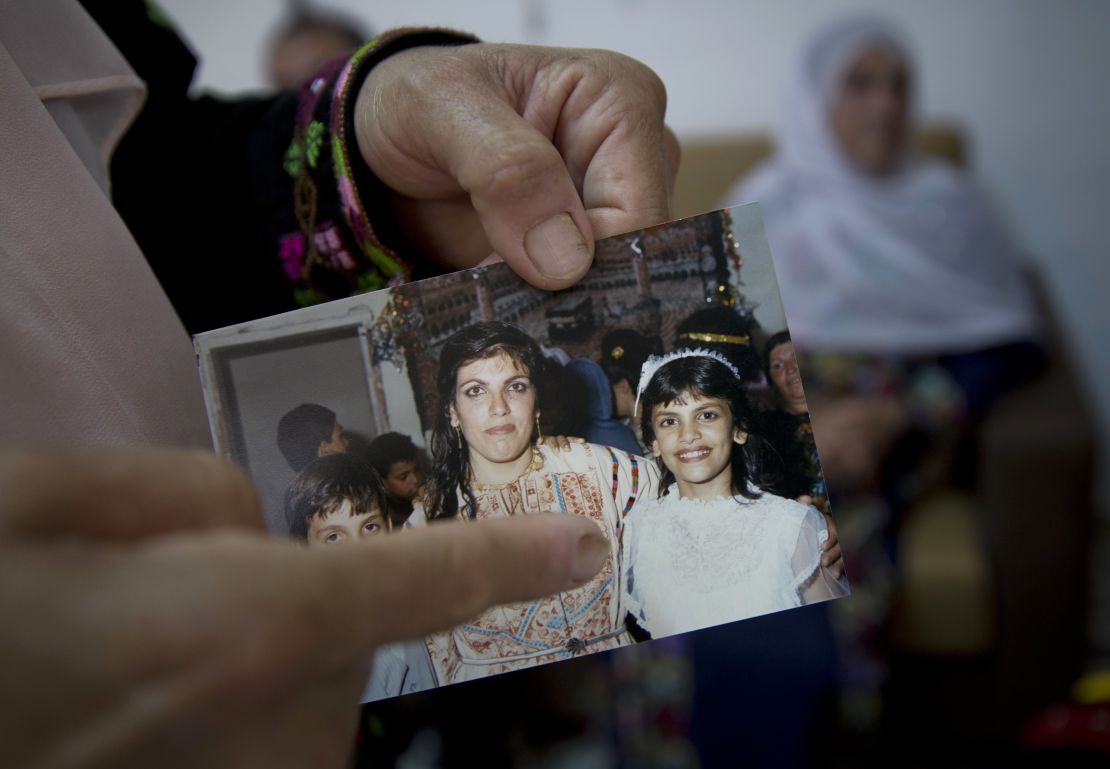 Fadwa Tlaib, an aunt of Rashida Tlaib points to a young Rashida in a 1987 picture with her mother, Fatima, and brother, Nader, at the family house in the West Bank village of Beit Ur al-Foqa on August 8, 2018.