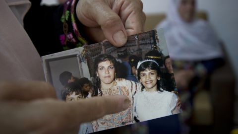 Fadwa Tlaib, an aunt of Rashida Tlaib points to a young Rashida in a 1987 picture with her mother, Fatima, and brother, Nader, at the family house in the West Bank village of Beit Ur al-Foqa on August 8, 2018.