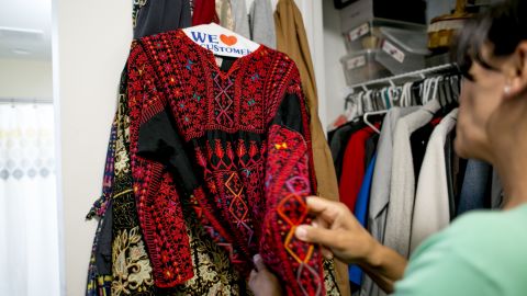 Rashida Tlaib shows her mother's thobe, a traditional Palestinian dress, in Detroit on August 10, 2018.
